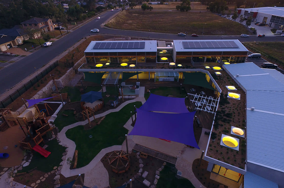 Aerial view of the Fit Kidz Learning Centre facility and outdoor playground at dusk