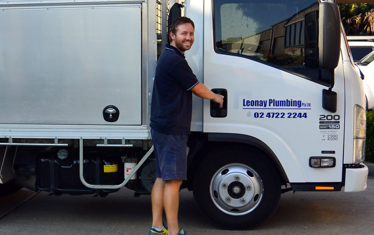A Leonay Plumbing team member beside a branded company truck